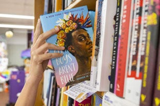 Oft-banned book All Boys Aren't Blue on a library shelf